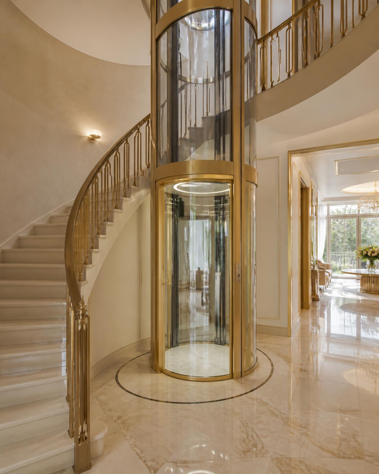 Glass elevator beside the staircase